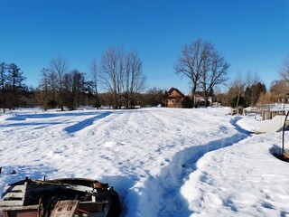 spring day in the Russian village snow well blue sky