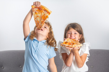 Funny kids eating pizza. Cute children little girl and boy eating tasty pizza.