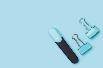 Office supplies on a blue pastel background with copy space.