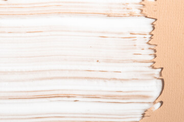 Texture of a cosmetic product on a beige background top view. Body cream, lotion, shampoo sample close-up.