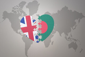 puzzle heart with the national flag of bangladesh and great britain on a world map background. Concept.