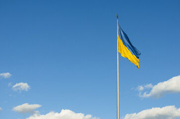 Ukraine flag isolated on the blue sky with clipping path. close up waving flag of Ukraine. flag symbols of Ukraine