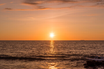 Fototapeta na wymiar The beautiful sunset over the horizon at Taplau Beach, Padang