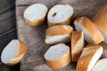 wheat baguette cut into pieces on a cutting board