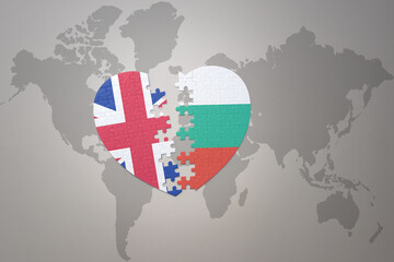 puzzle heart with the national flag of bulgaria and great britain on a world map background. Concept.