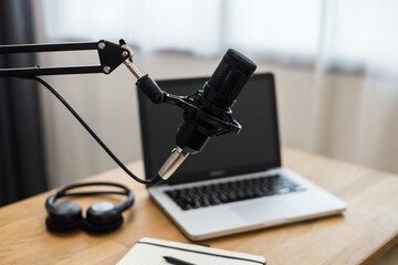 Condenser microphone in recording home studio. Content creator working with laptop host streaming...