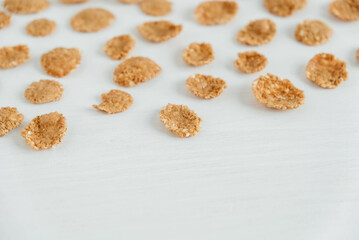 Crispy healthy dry cereal flakes on white background
