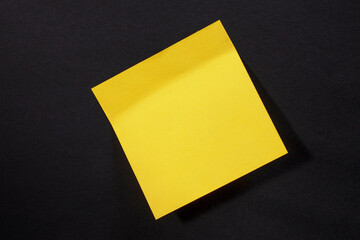 Yellow sticker for notes on black background