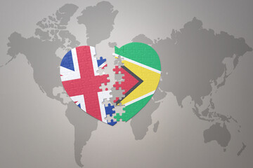 puzzle heart with the national flag of guyana and great britain on a world map background. Concept.