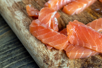 cutting fish fillets during the preparation of a dish of red salmon fish