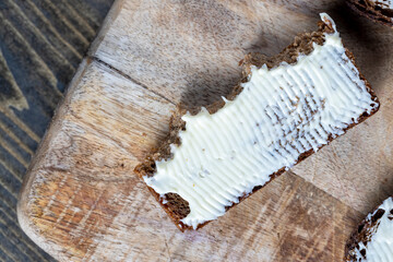 slices of black sliced bread with butter spread from milk