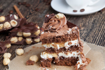 a piece of cake made of chocolate sponge cake cream and caramel with hazelnuts