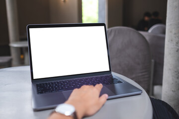 Mockup image of a woman working and typing on laptop with blank white desktop screen in office