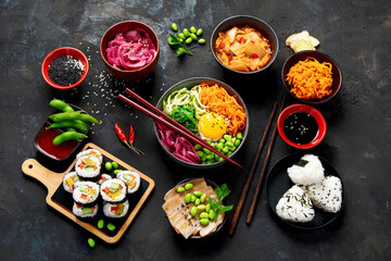 Assortment of Korean food on dark background.