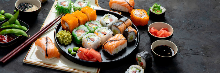 Sushi assortment on dark background.