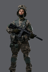 Photo of patriotic militant woman holding rifle dressed in camouflage clothes.