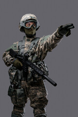 Shot of militant woman dressed in uniform with helmet and eyewear commanding attack.