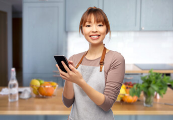 cooking, technology and people concept - happy smiling female chef or waitress in apron showing...