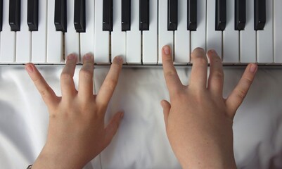 long beautiful fingers on piano keyboard