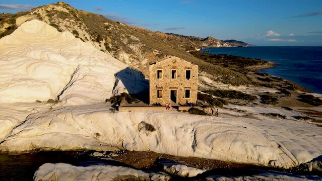 Punta Bianca, Agrigento in Sicily Italy White beach with old ruins of an abandoned stone house on white cliffs. Sicilia Italy, couple men and woman on vacation in Italy