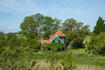 Fototapeta na wymiar Oterleek, Netherlands, May 2022. Traditional farmhouse with barns in the countryside of western Friesland.