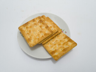 Flat dry toast made from savory wheat sprinkled with sugar is called cracker biscuit