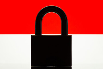 Silhouette of closed lock on the background of flag of Indonesia. Sanctions, restrictions on country concept.