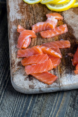 cutting fish fillets during the preparation of a dish of red salmon fish