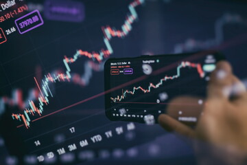 Trader investor broker holding finger using cell phone app executing financial stock trade market...