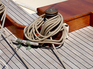 The rope on the teak deck of a sailboat