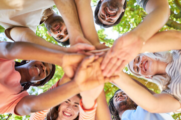 Successful young start-up team stacking hands