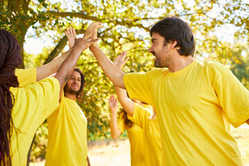 Startup team makes high five for motivation and team building