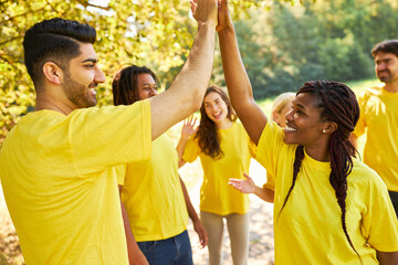 Young people in the startup team celebrate success with high five