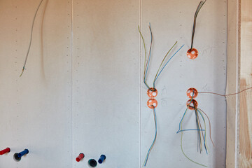 Wall with cables for electrical installation in interior design