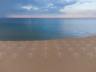 Aerial View from above, stunning aerial view of an empty beach with beach umbrellas.