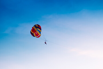 Parasailing in blue sky. Sports, active leisure, travel, vacation concept