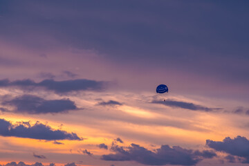 Parasailing on sunset and blue sky background in tropical country