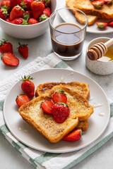 Homemade french cinnamon toast with strawberries, honey and coffee. Morning breakfast, brunch or lunch concept. Selective focus.