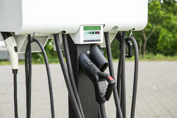 Electric Vehicle charging Ev station with plug of power cable supply for Ev car. Smart Enegy.