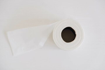Roll of white toilet paper on a white background