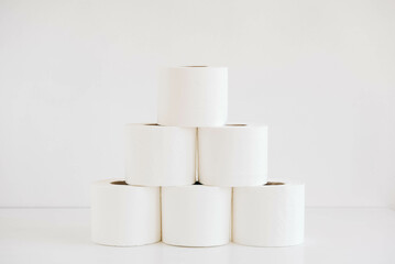 Rolls of white toilet paper on a white background