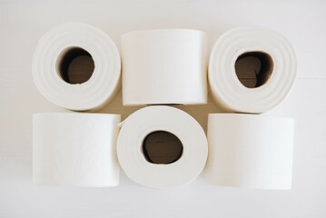 Rolls of white toilet paper on a white background
