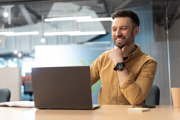 Cheerful Businessman Using Laptop Working Online In Office