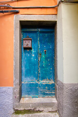Old blue wooden front door with mailbox