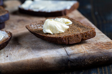 slices of black sliced bread with butter spread from milk