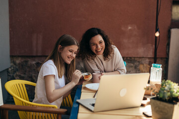 family have breakfast in home backyard.