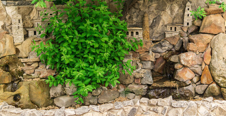 landscape design element in the form of a small mountain village made of natural stone