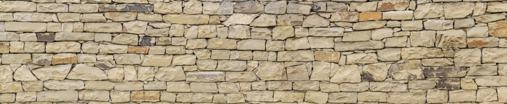 horizontal background, texture - wall of roughly hewn natural light stone