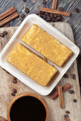 multi-layered cake made of soft cakes and buttercream with honey