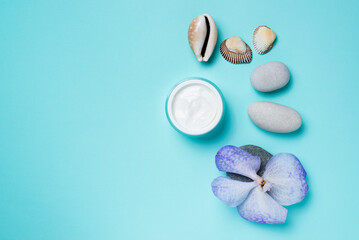 cream for face,blue orchid,stones on a blue background,facial massage